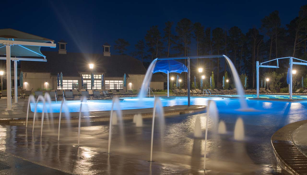 Nightshote of Bay Forest basketball court and pool